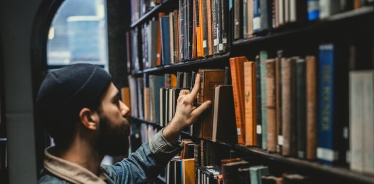 Man picking a book in a library